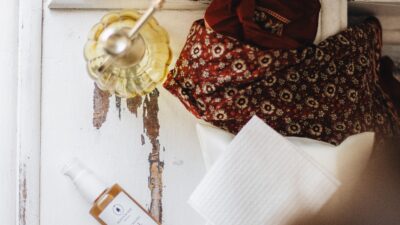 Cozy flatlay of artisan skincare products in warm tones, perfect for self-care routines