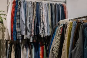 Assorted clothing on racks in a thrift shop showcasing various styles and colors