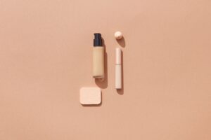 Flat lay of beauty products on a warm brown background