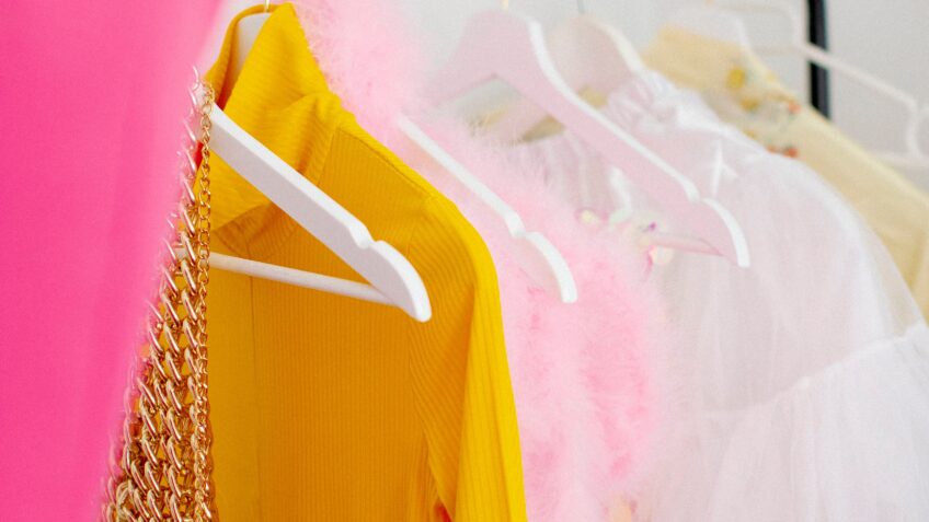 Vibrant garments on a clothes rack showcasing diverse styles and colors