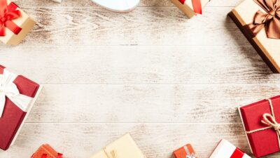 Top view of colorful gift boxes arranged on a rustic wooden table