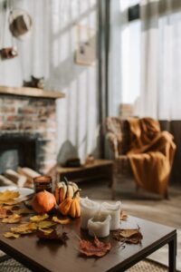 Warm and inviting living room with pumpkins and candles on a wooden table