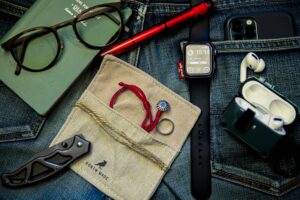 Meticulously organized flat lay showcasing everyday carry essentials on denim
