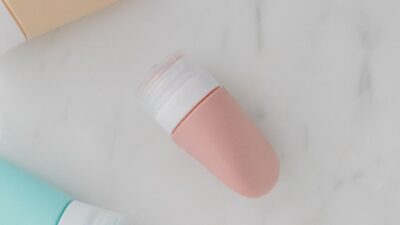 Flat lay of skincare bottles on a smooth marble surface