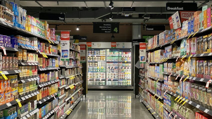 Grocery store aisle showing store-brand and name-brand products side by side